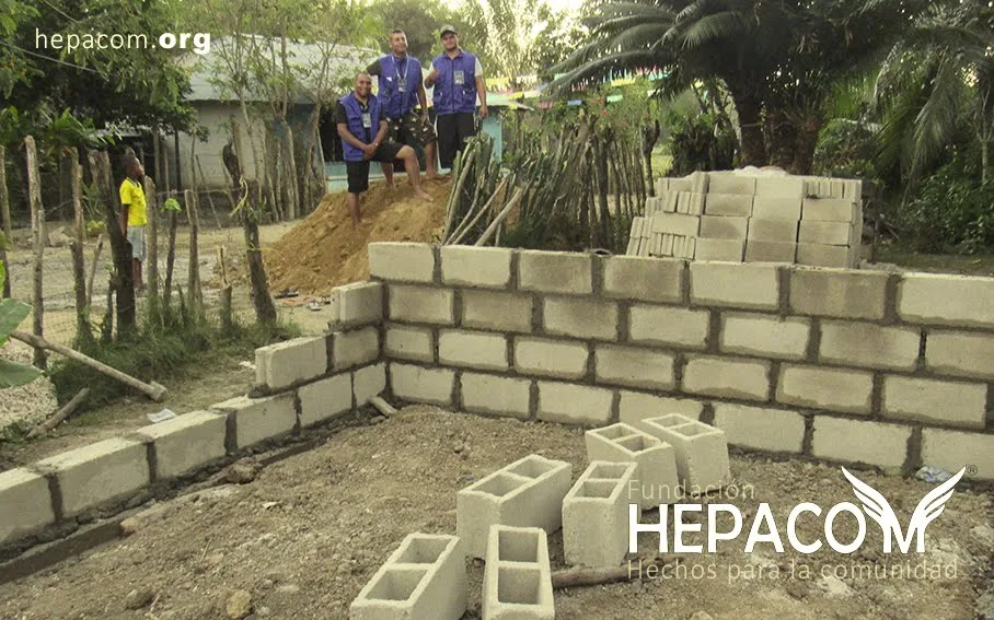 The block walls going up, alongside the volunteers