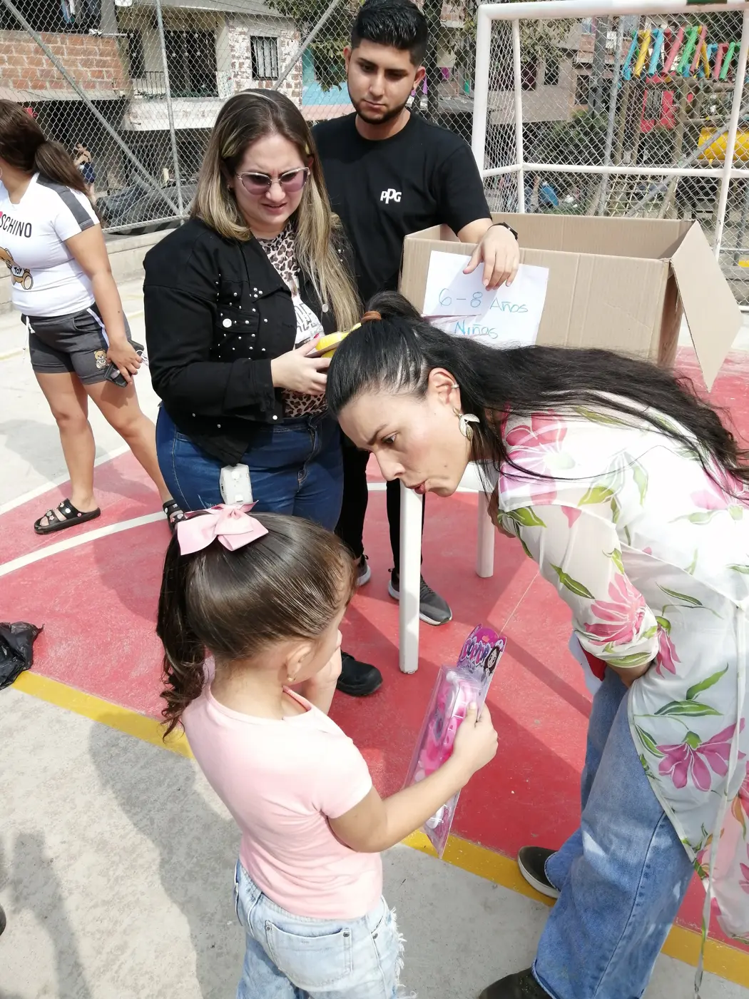 Children receiving gifts at the Hepacom Foundation's Christmas event