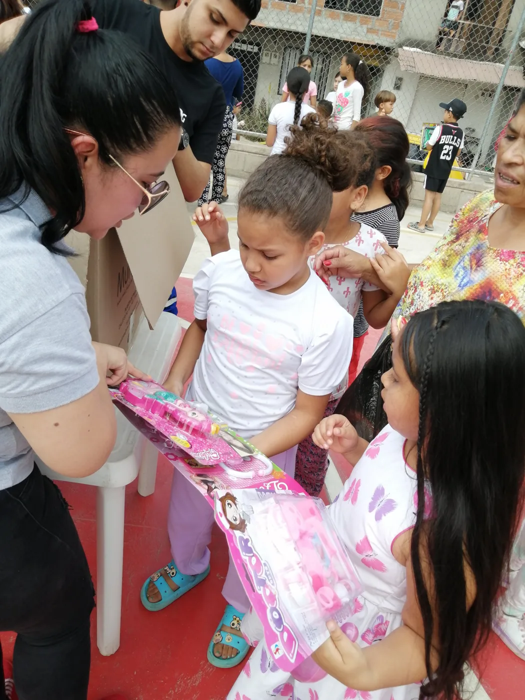 Children receiving gifts at the Hepacom Foundation's Christmas event